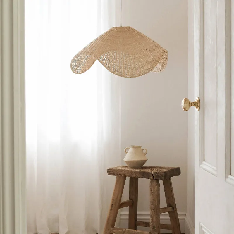 Handmade bamboo rattan chandelier with woven straw and willow lampshade in warm light