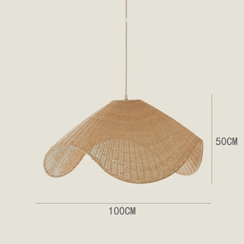 Handmade bamboo rattan chandelier with woven straw and willow lampshade in warm light