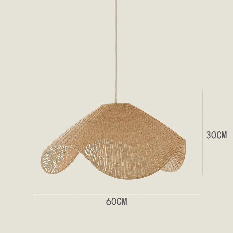 Handmade bamboo rattan chandelier with woven straw and willow lampshade in warm light