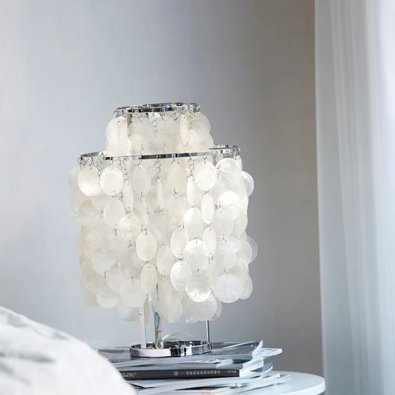 Shell-shaped bedside table lamp in chrome finish measuring 30cm diameter by 46cm tall