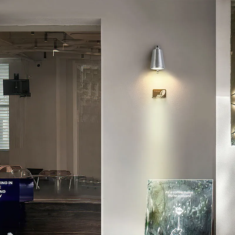 Industrial-style cast aluminum horseshoe wall lamp for outdoor use in sand black finish.
