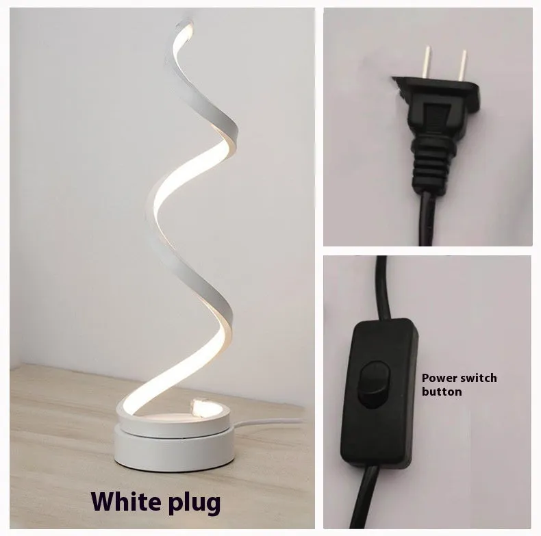 Black minimalist LED bedside table lamp with aluminium shade and metal base on wooden table