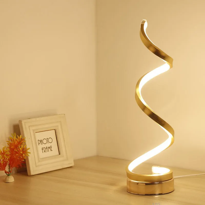 Black minimalist LED bedside table lamp with aluminium shade and metal base on wooden table