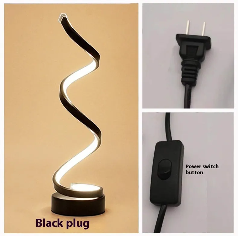 Black minimalist LED bedside table lamp with aluminium shade and metal base on wooden table