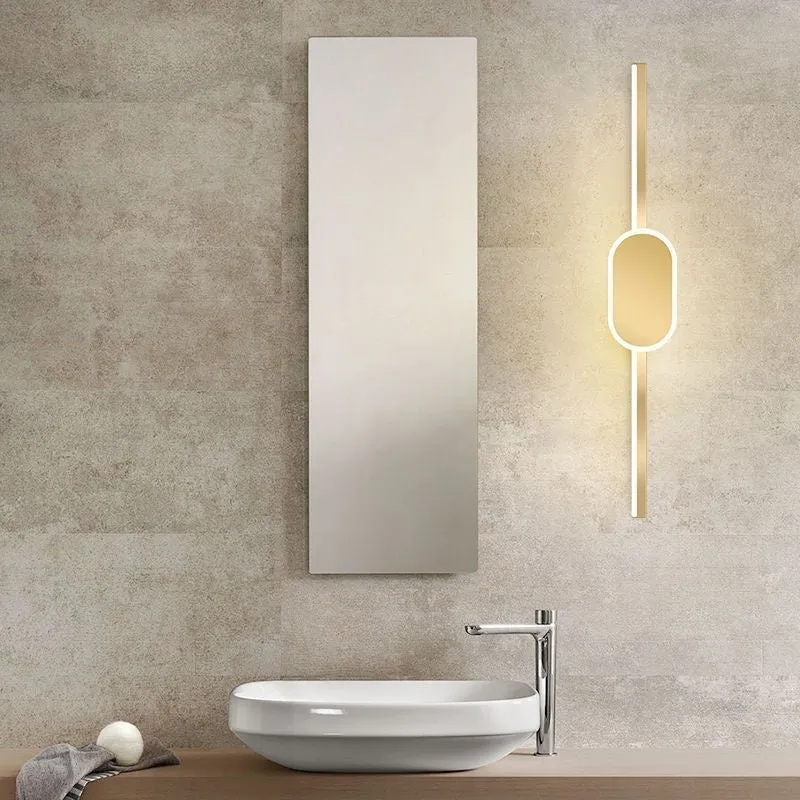 Modern bathroom mirror cabinet with LED vanity lights and a gold-toned frame.