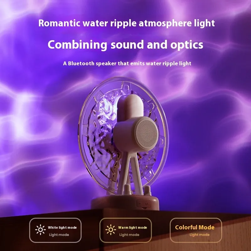 Pink Ferris wheel Bluetooth speaker projecting colourful water ripple light patterns on a surface.