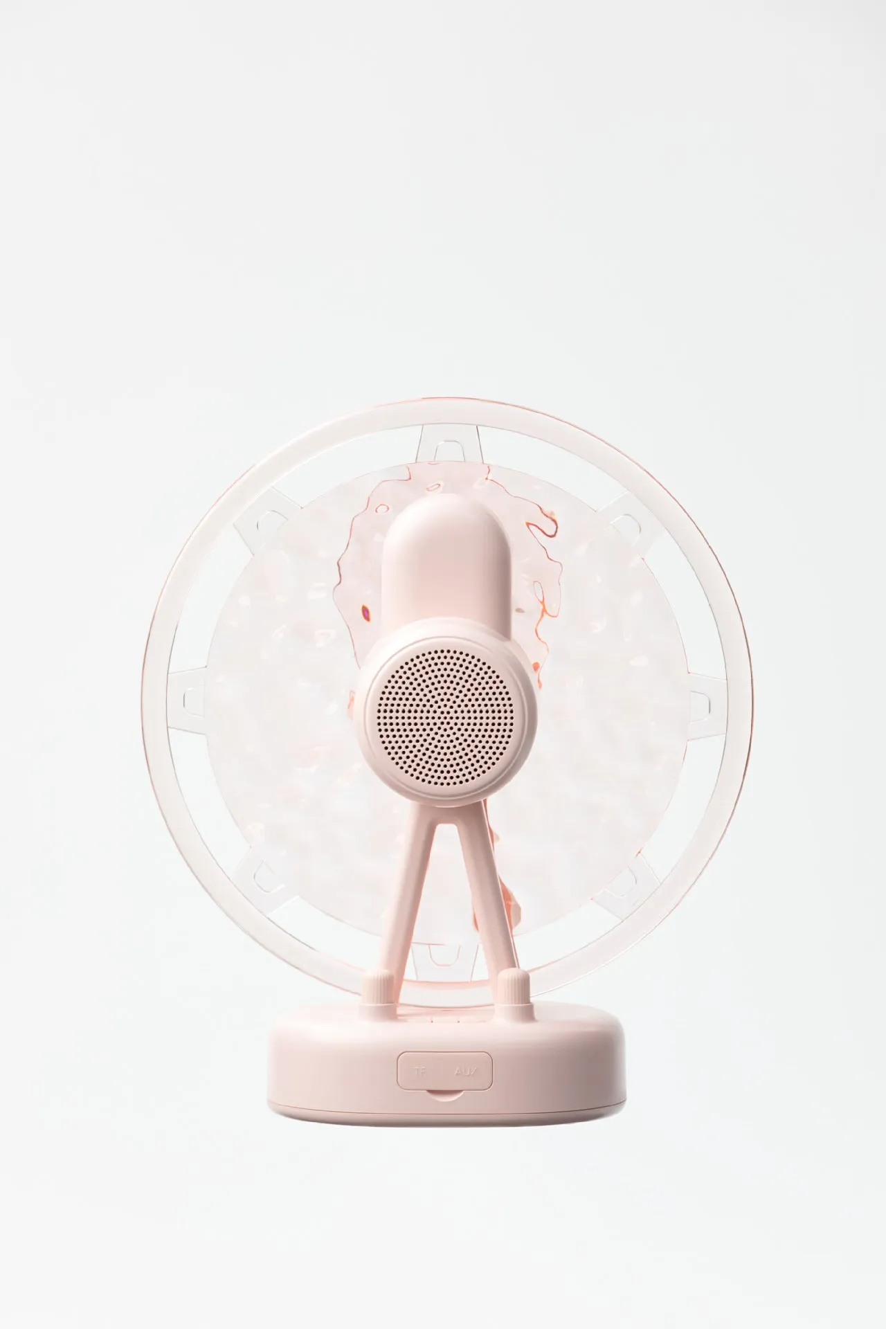 Pink Ferris wheel Bluetooth speaker projecting colourful water ripple light patterns on a surface.