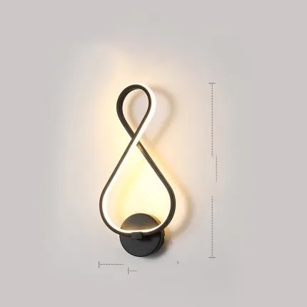 Nordic minimalist LED wall lamp with silicone shade in black finish mounted beside bed