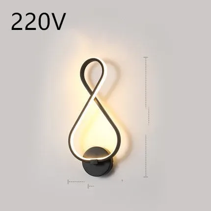 Nordic minimalist LED wall lamp with silicone shade in black finish mounted beside bed