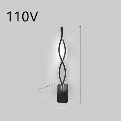Nordic minimalist LED wall lamp with silicone shade in black finish mounted beside bed