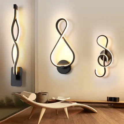 Nordic minimalist LED wall lamp with silicone shade in black finish mounted beside bed