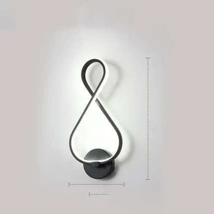 Nordic minimalist LED wall lamp with silicone shade in black finish mounted beside bed