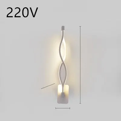 Nordic minimalist LED wall lamp with silicone shade in black finish mounted beside bed