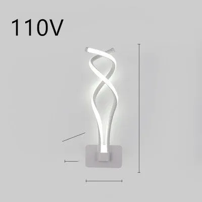 Nordic minimalist LED wall lamp with silicone shade in black finish mounted beside bed