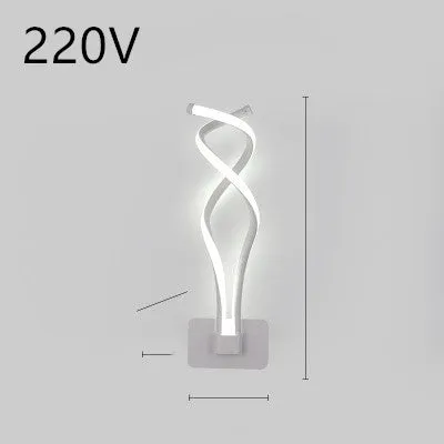 Nordic minimalist LED wall lamp with silicone shade in black finish mounted beside bed