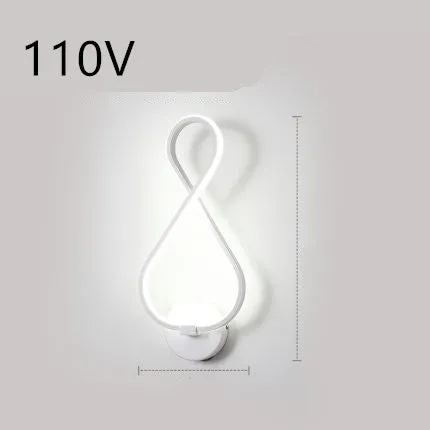 Nordic minimalist LED wall lamp with silicone shade in black finish mounted beside bed