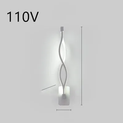 Nordic minimalist LED wall lamp with silicone shade in black finish mounted beside bed