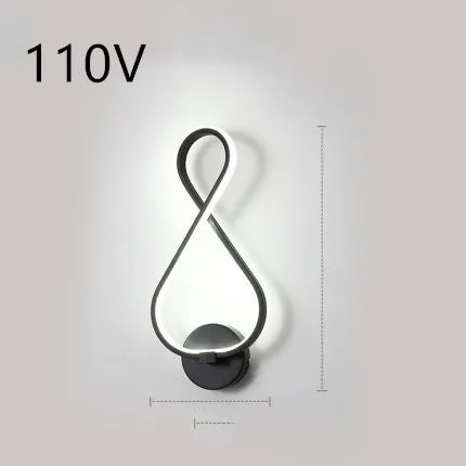 Nordic minimalist LED wall lamp with silicone shade in black finish mounted beside bed