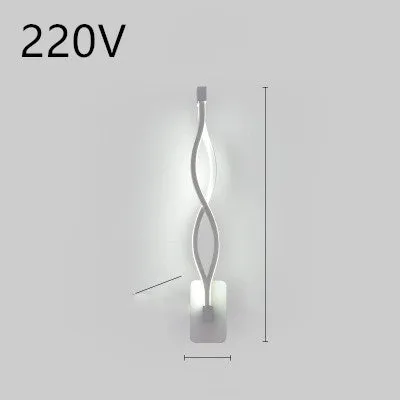 Nordic minimalist LED wall lamp with silicone shade in black finish mounted beside bed