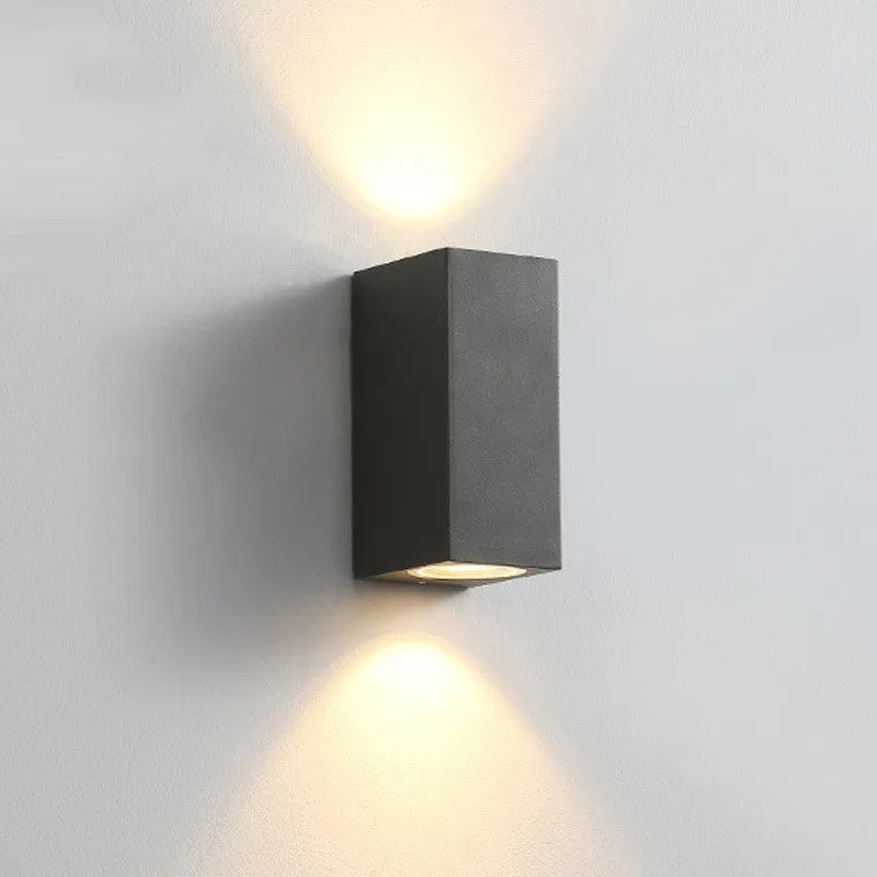 Modern aluminium LED wall lamp in a black finish mounted on a wall.