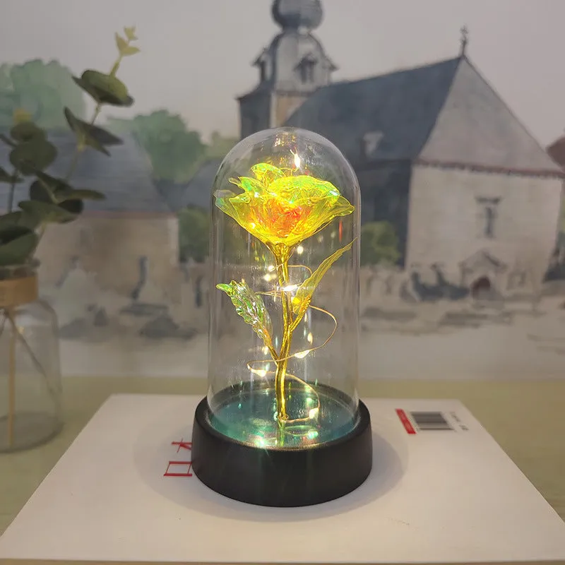 Small decorative night lamp with plastic flower cover and black base, showing coloured light option.