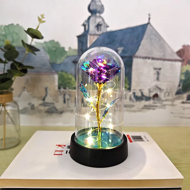 Small decorative night lamp with plastic flower cover and black base, showing coloured light option.