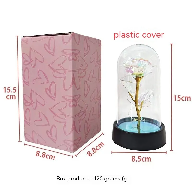 Small glass cover night lamp with plastic base and multiple LED colour options on a table.
