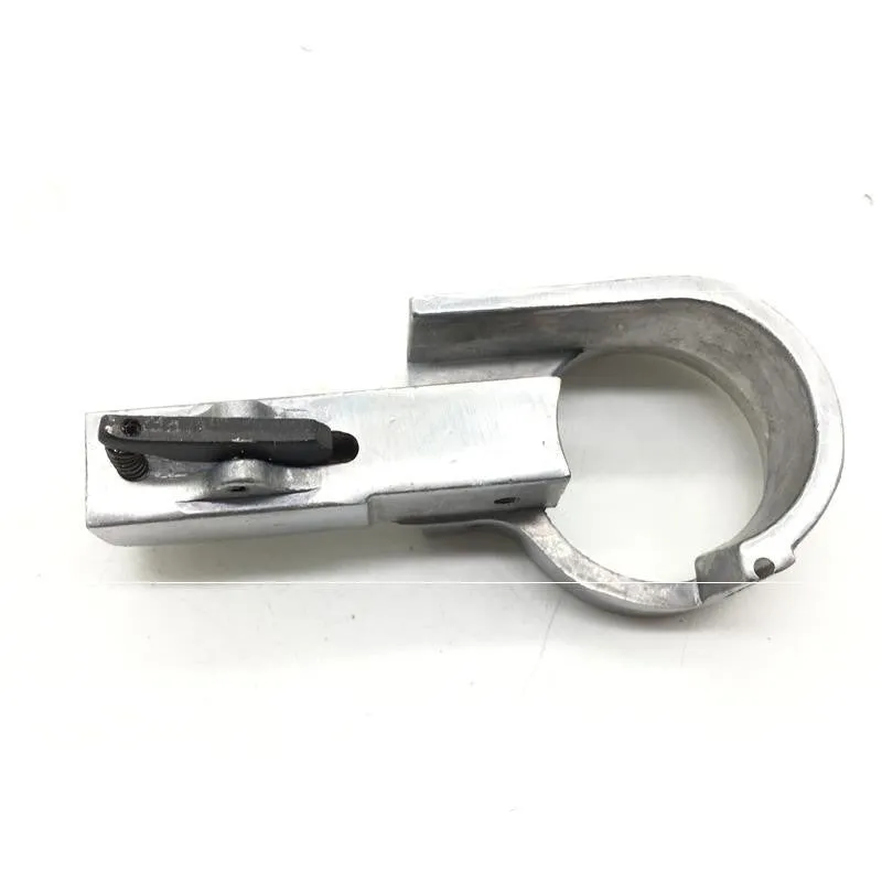 Set of metal pneumatic belt machine accessories including rollers, blades, a switch, and couplings on a workbench.