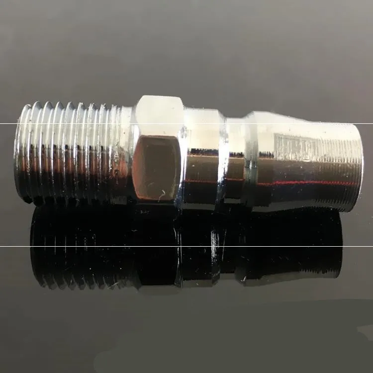 Set of metal pneumatic belt machine accessories including rollers, blades, a switch, and couplings on a workbench.