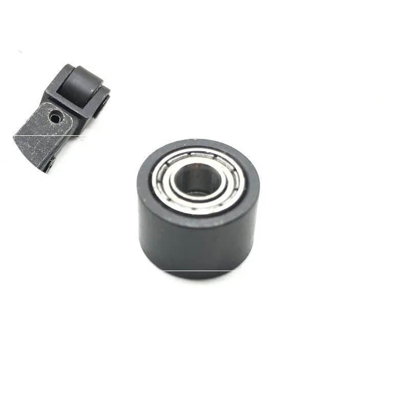 Set of metal pneumatic belt machine accessories including rollers, blades, a switch, and couplings on a workbench.