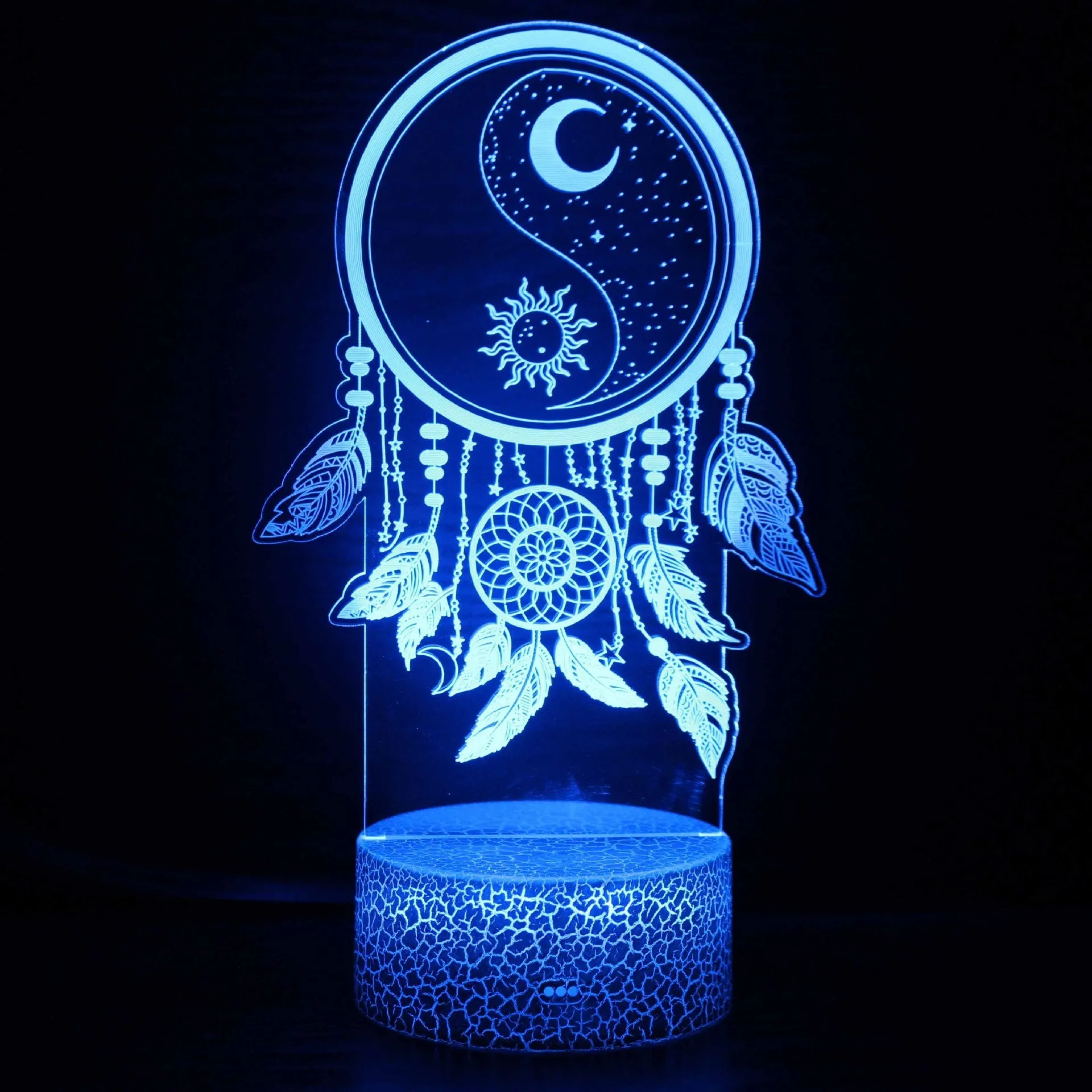 Cartoon-style 3D LED night light with black touch base and remote control on a bedside table.