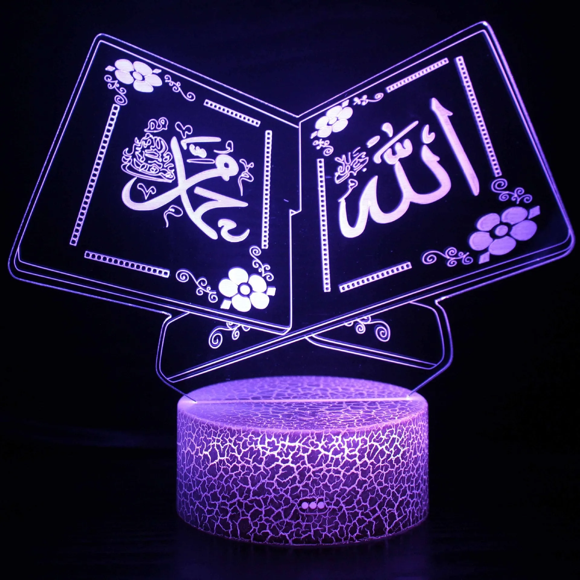Cartoon-style 3D LED night light with black touch base and remote control on a bedside table.