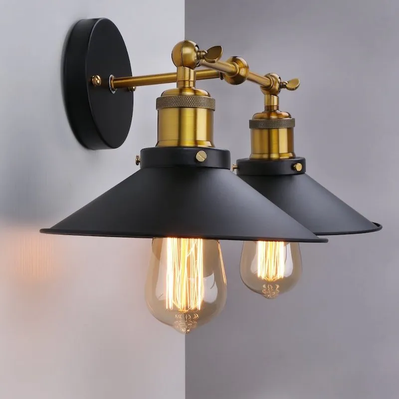 Black double head American retro industrial style iron wall lamp on a dark wall.