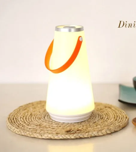 White rechargeable LED lantern night light on a wooden bedside table.