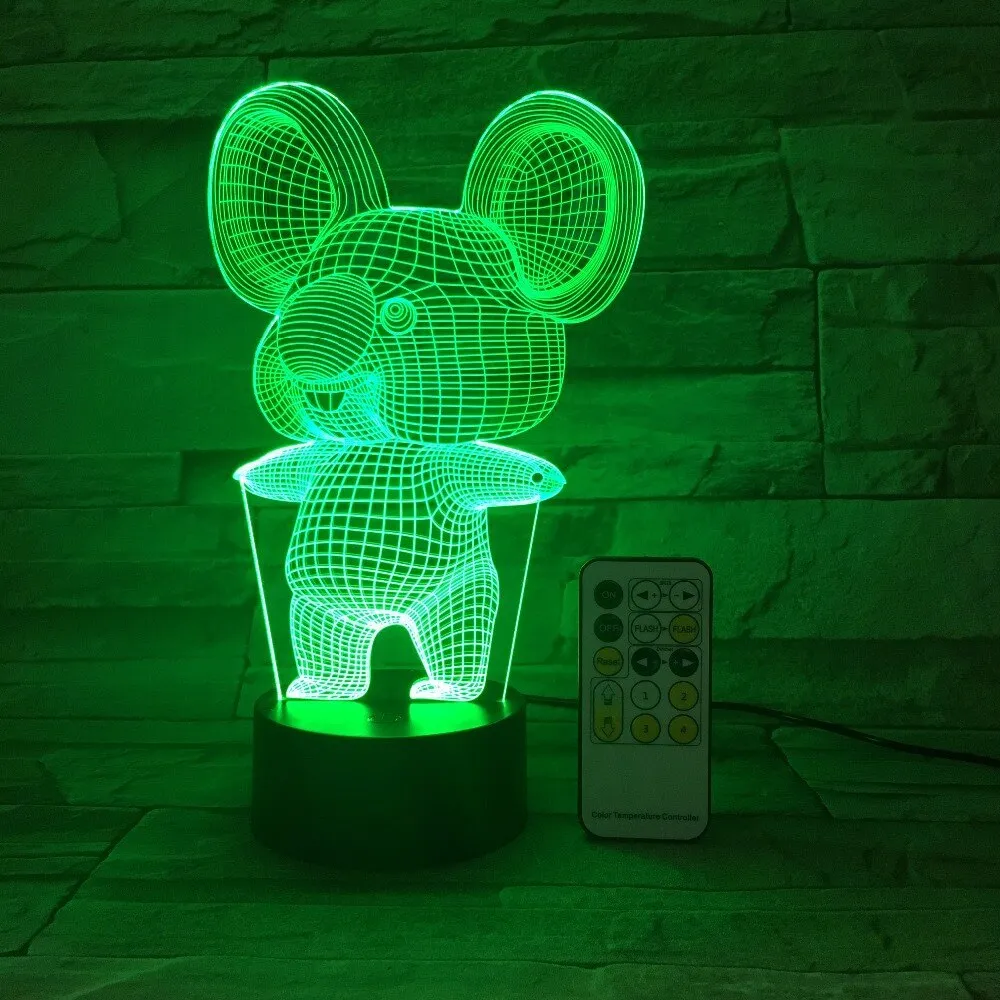 Koala-shaped night light with remote control showing seven colour options on a bedside table
