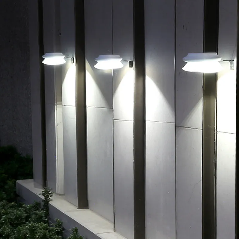 Solar-powered outdoor fence wall lamp with Southeast Asian design mounted on garden fence