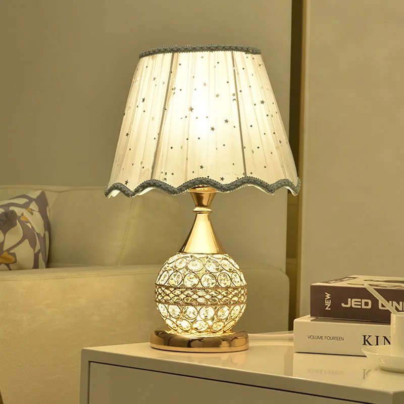 Gold crystal desk lamp with hand-finished pendant and iron art base on wooden surface