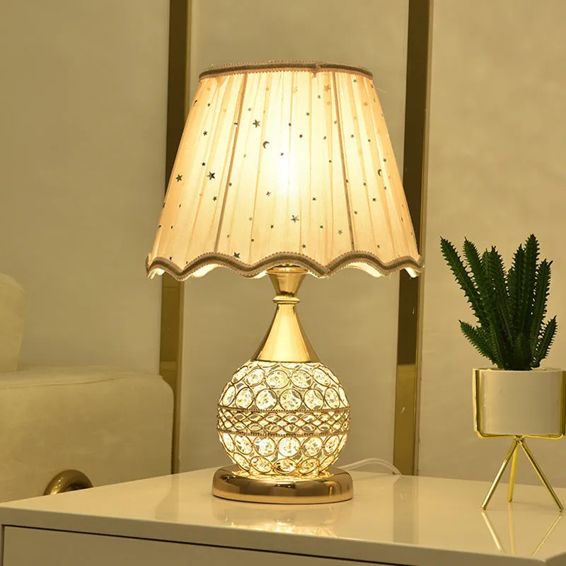 Gold crystal desk lamp with hand-finished pendant and iron art base on wooden surface
