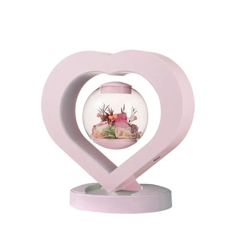 Pink preserved rose ornament with LED lights, shown with and without a decorative base.