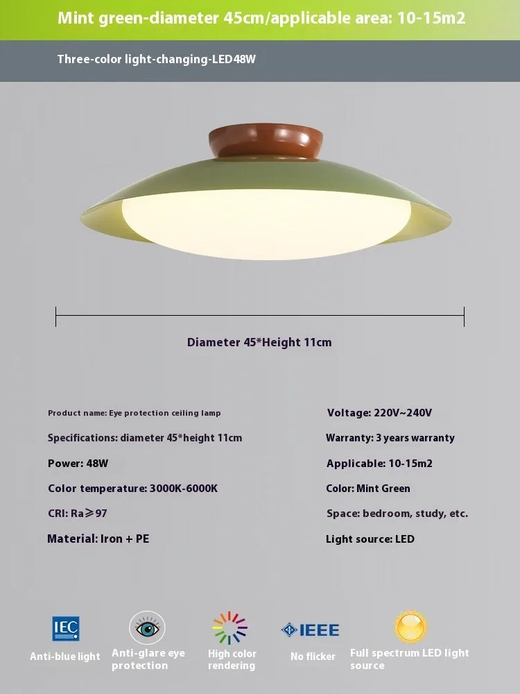 Modern cream style flying saucer shaped ceiling lamp in an iron shade.