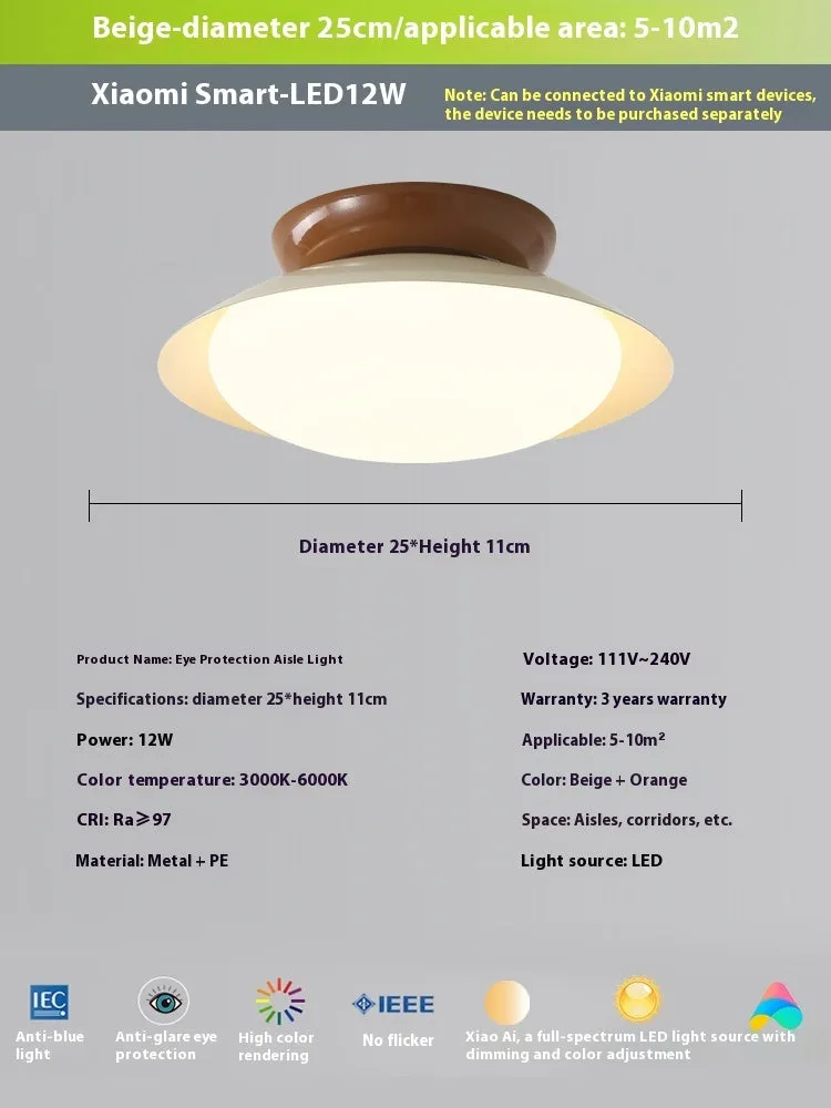 Modern cream style flying saucer shaped ceiling lamp in an iron shade.