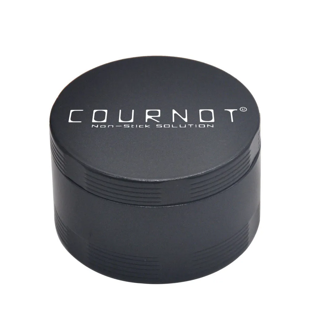 Black four-layer metal smoke grinder with diamond teeth on a grey background