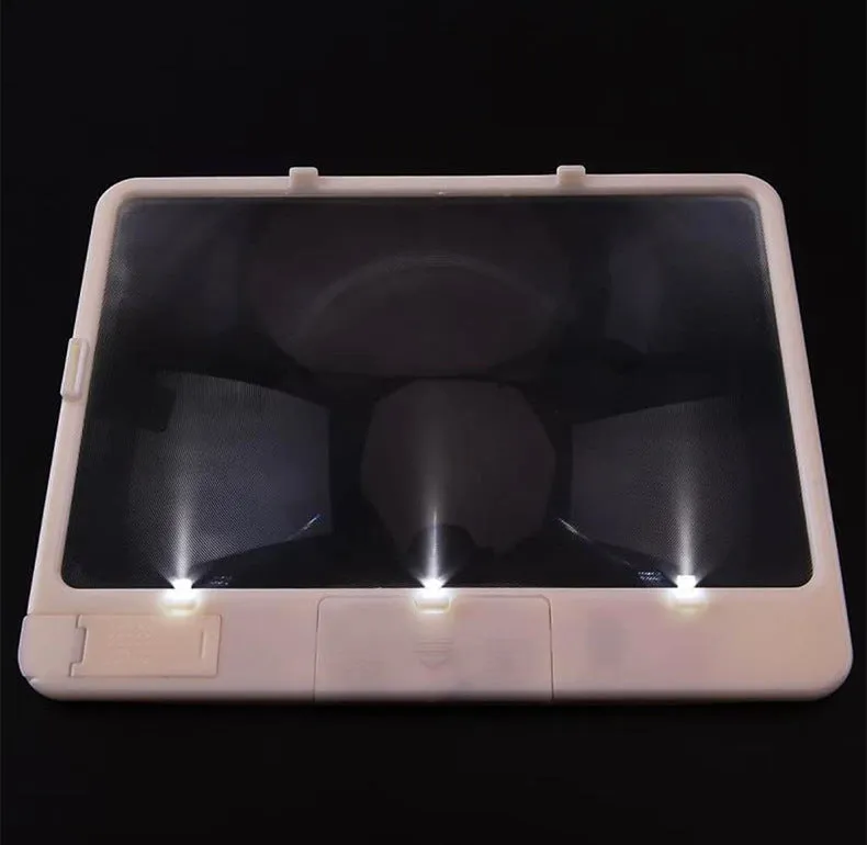 Black or white magnifying glass with integrated LED reading lamp, showing 180x140mm size and 3x magnification lens.