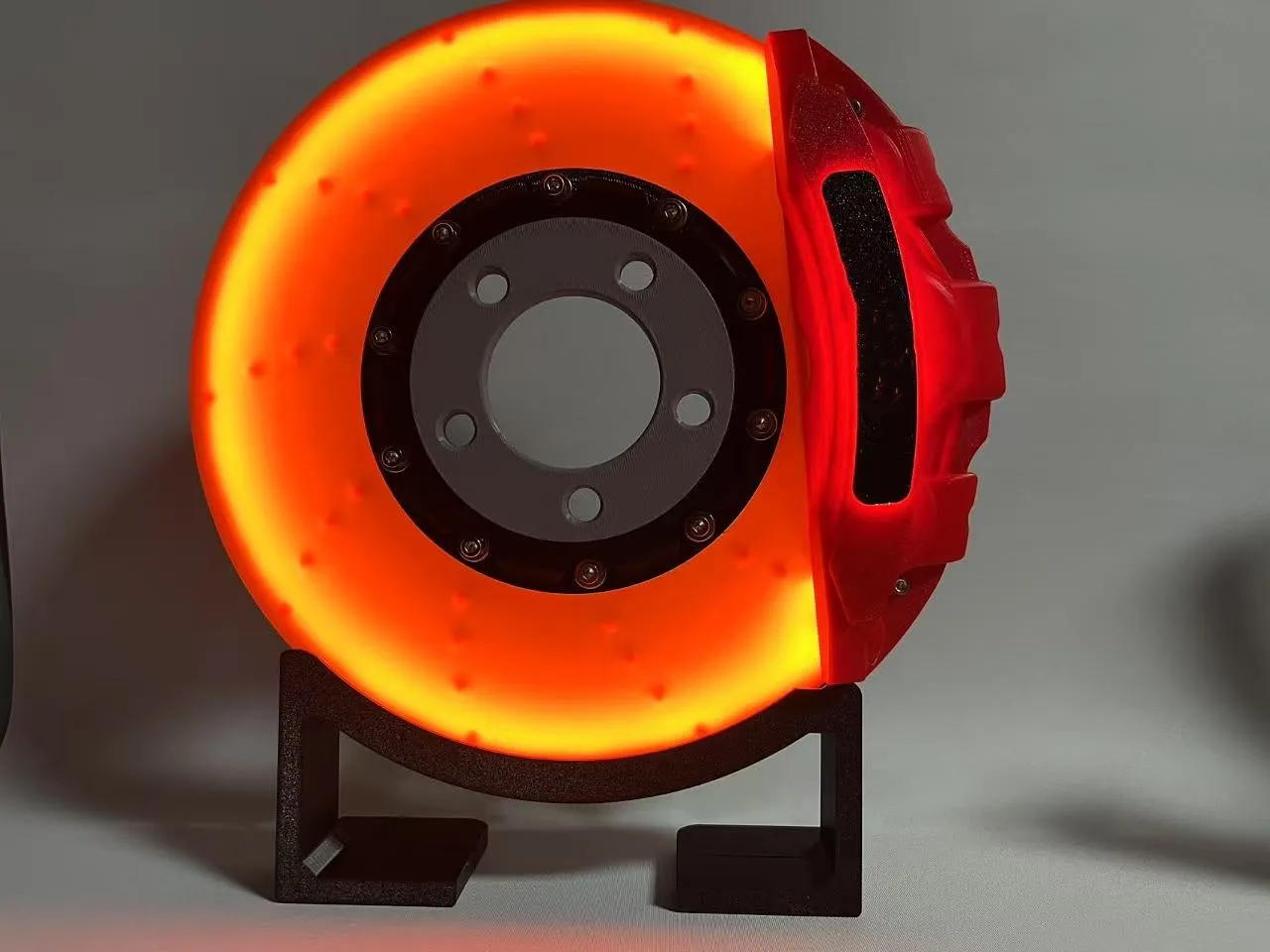 Brake disc themed LED desktop night light in blue caliper colour with touch control