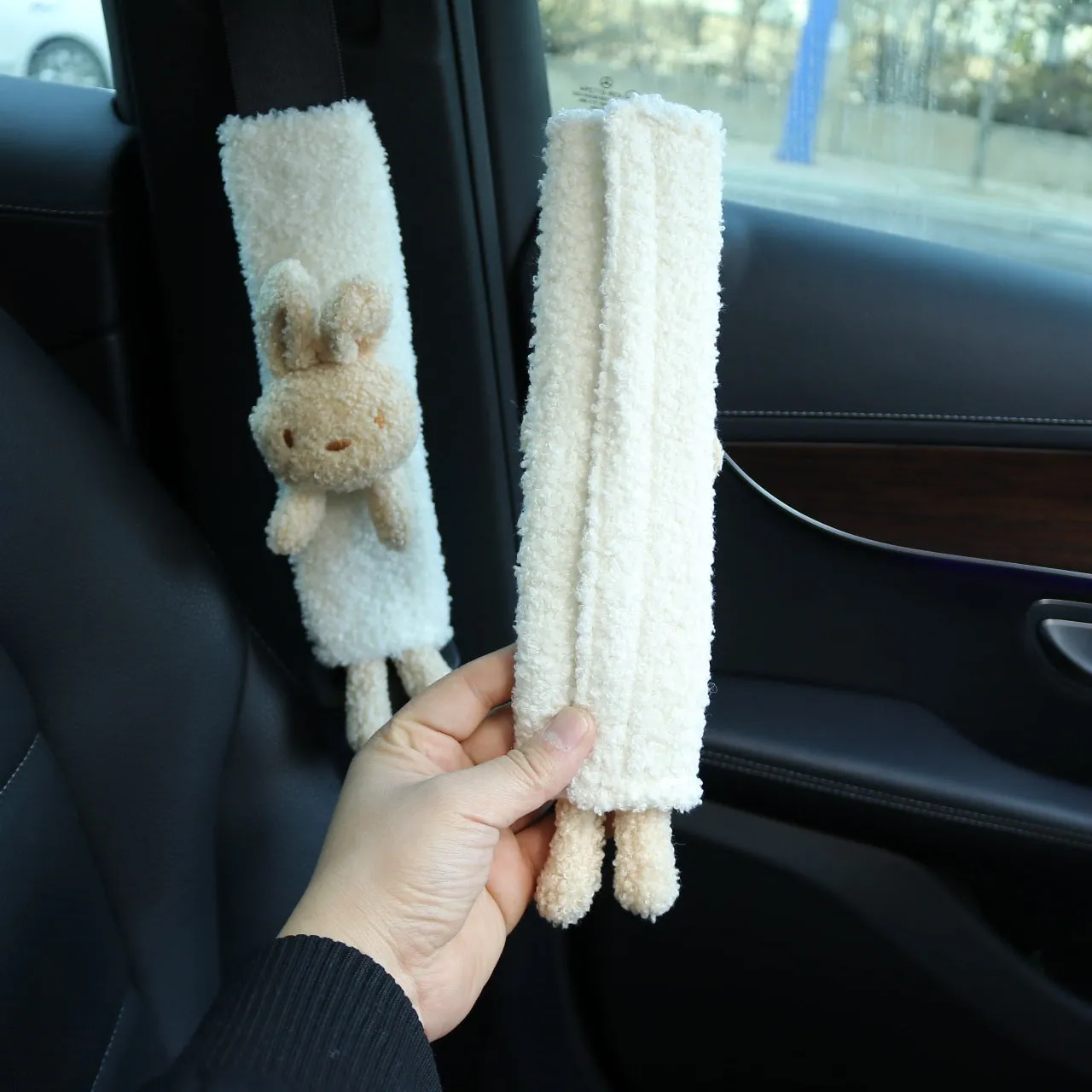 Cartoon rabbit and bear designs on a soft lamb wool car seatbelt shoulder protector.