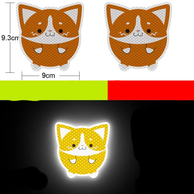 A pair of diamond-grade reflective safety stickers for vehicles, showing sample designs like a smiling cat or tiger.