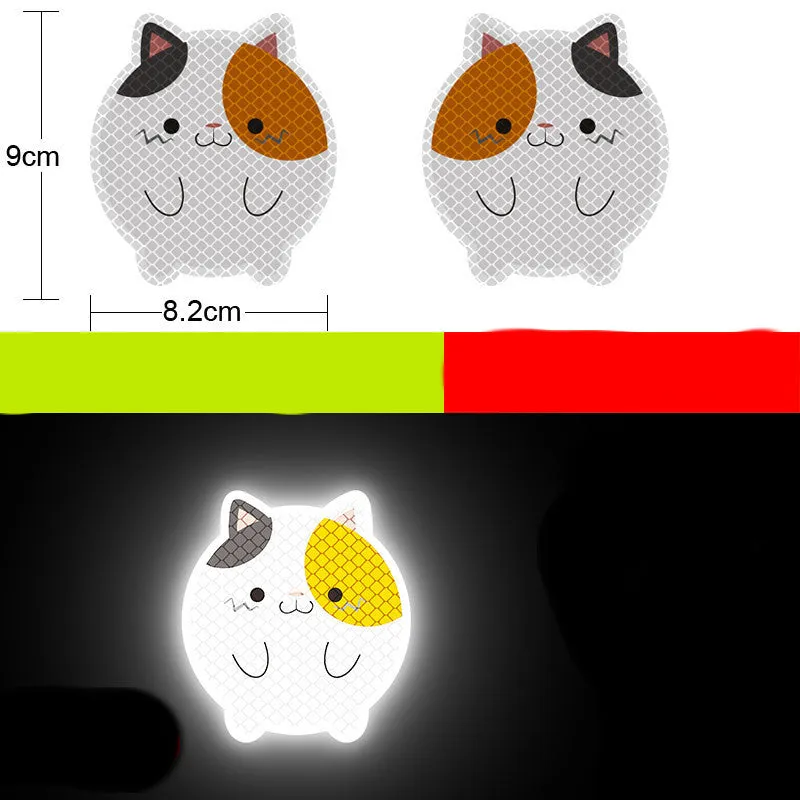 A pair of diamond-grade reflective safety stickers for vehicles, showing sample designs like a smiling cat or tiger.