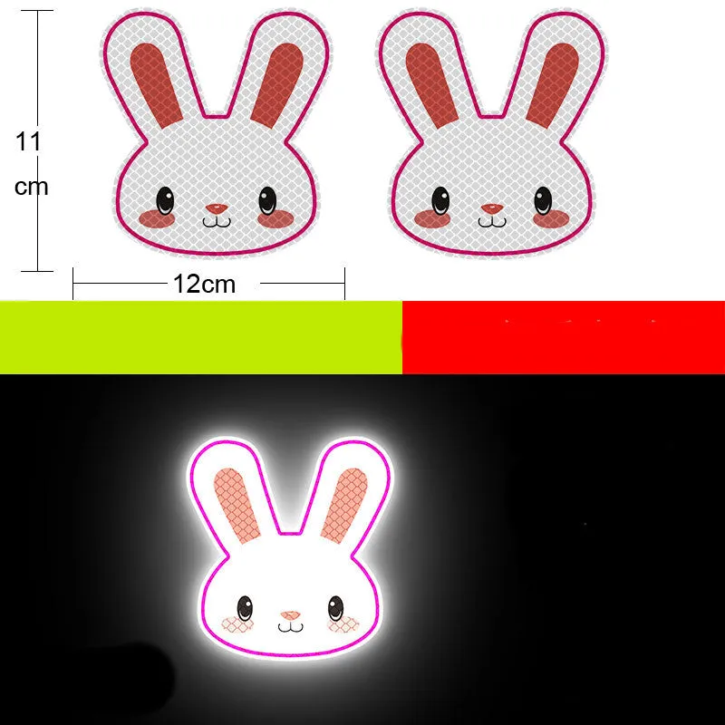 A pair of diamond-grade reflective safety stickers for vehicles, showing sample designs like a smiling cat or tiger.