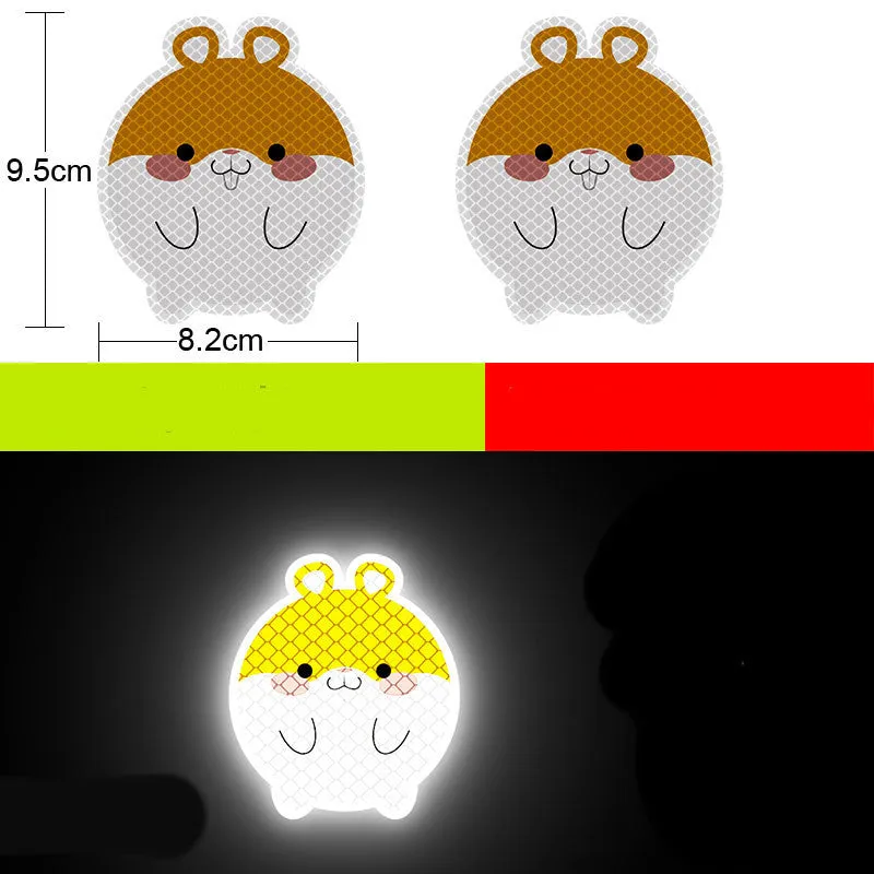 A pair of diamond-grade reflective safety stickers for vehicles, showing sample designs like a smiling cat or tiger.