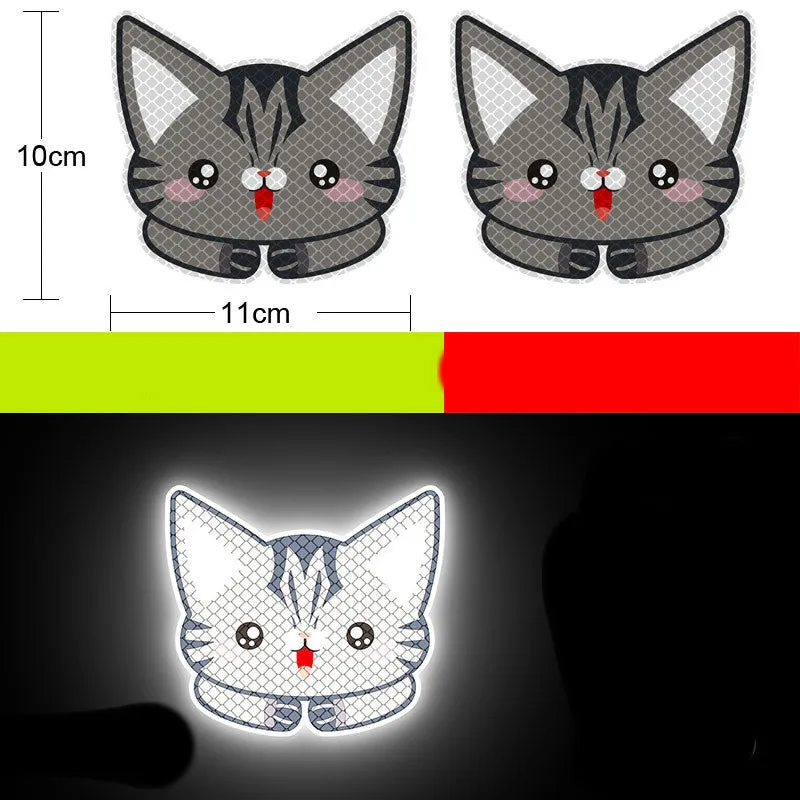 A pair of diamond-grade reflective safety stickers for vehicles, showing sample designs like a smiling cat or tiger.